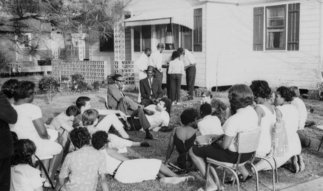 Civil rights workers gather on lawn outside Hicks House in 1965